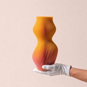 A white-gloved hand holding the hand-painted Breeze Limited Edition vase